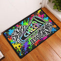 Colorful cheerleading doormat displayed in an entryway on a wood floor beside a white door