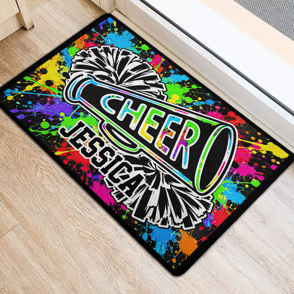 Cheerleading pom-pom and megaphone doormat styled near a doorway on light wood flooring