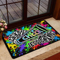 Bright cheerleading entryway mat with pom-poms and megaphone displayed beside a glass door