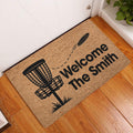 Disc golf welcome doormat displayed at an indoor entryway with a basket and flying disc design