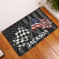 Dirt track racing doormat displayed at a front door on hardwood flooring with crossed racing flags