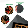 Close-up product detail showing the racing print, rubber backing and textured doormat construction