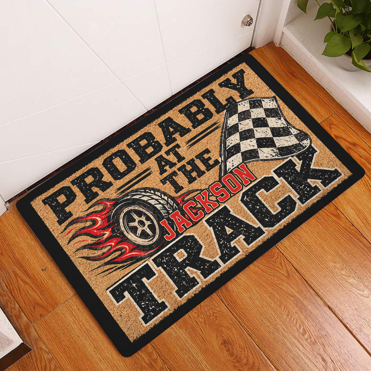 Dirt track racing doormat displayed at a front door on a warm wood entryway floor