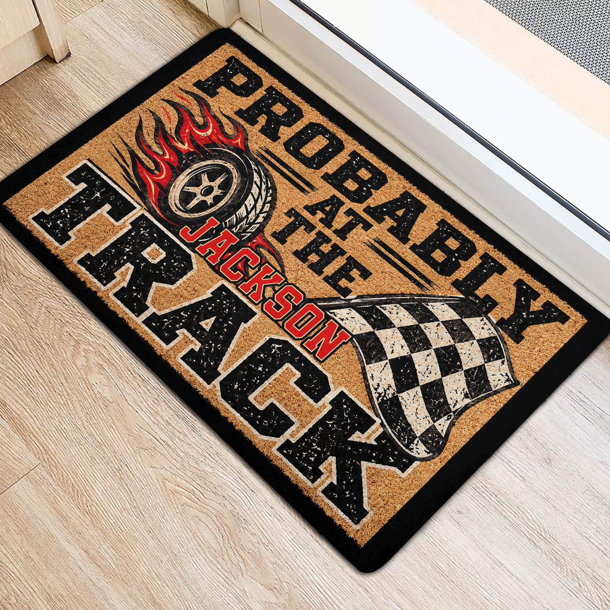 Racing tire and checkered flag doormat styled beside a doorway on a light wood floor