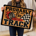 Dirt track racing doormat held indoors, featuring a flaming tire and checkered flag design