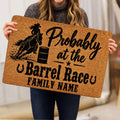 Barrel racing doormat held indoors, showing mounted rider, barrel and western artwork