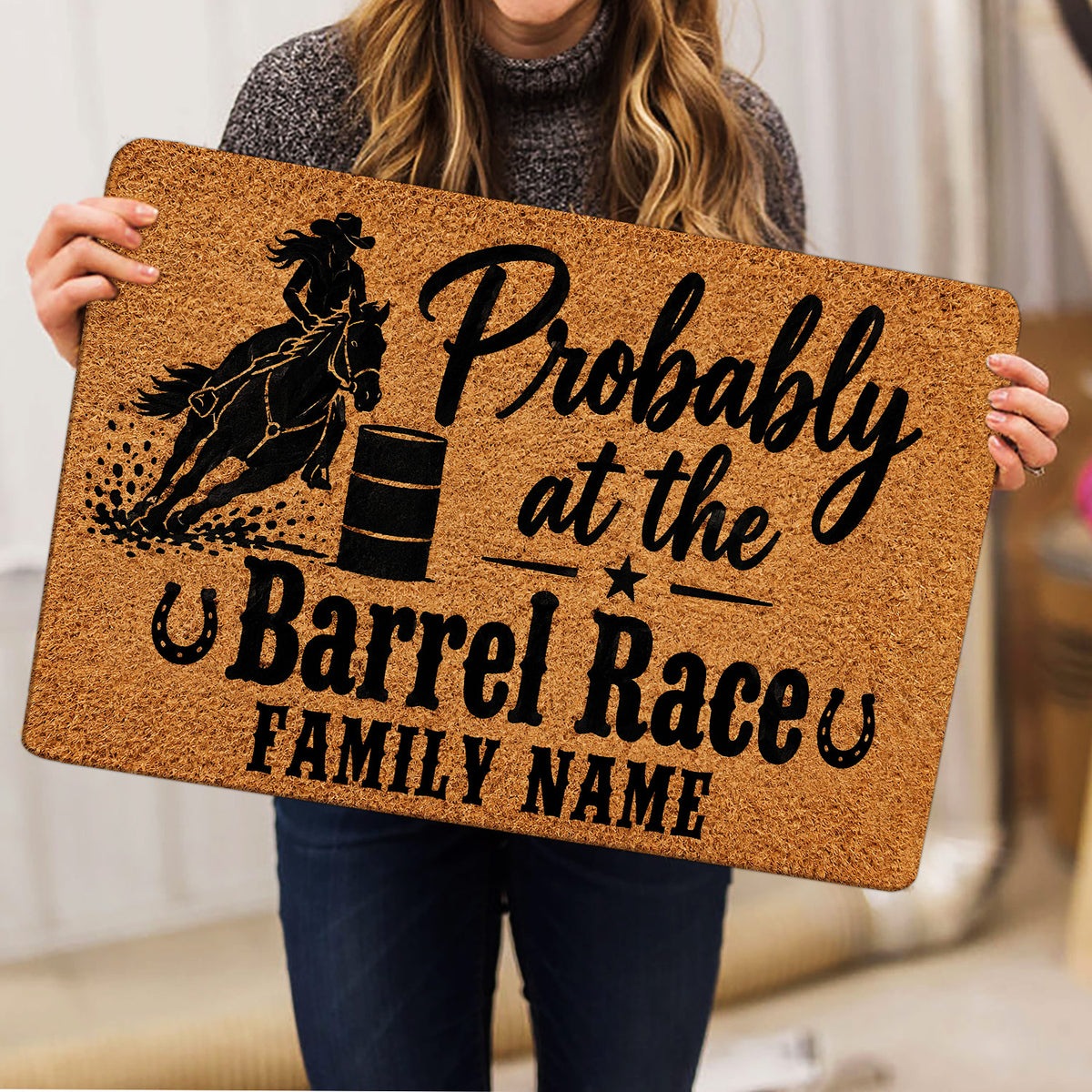 Barrel racing doormat held indoors, showing mounted rider, barrel and western artwork