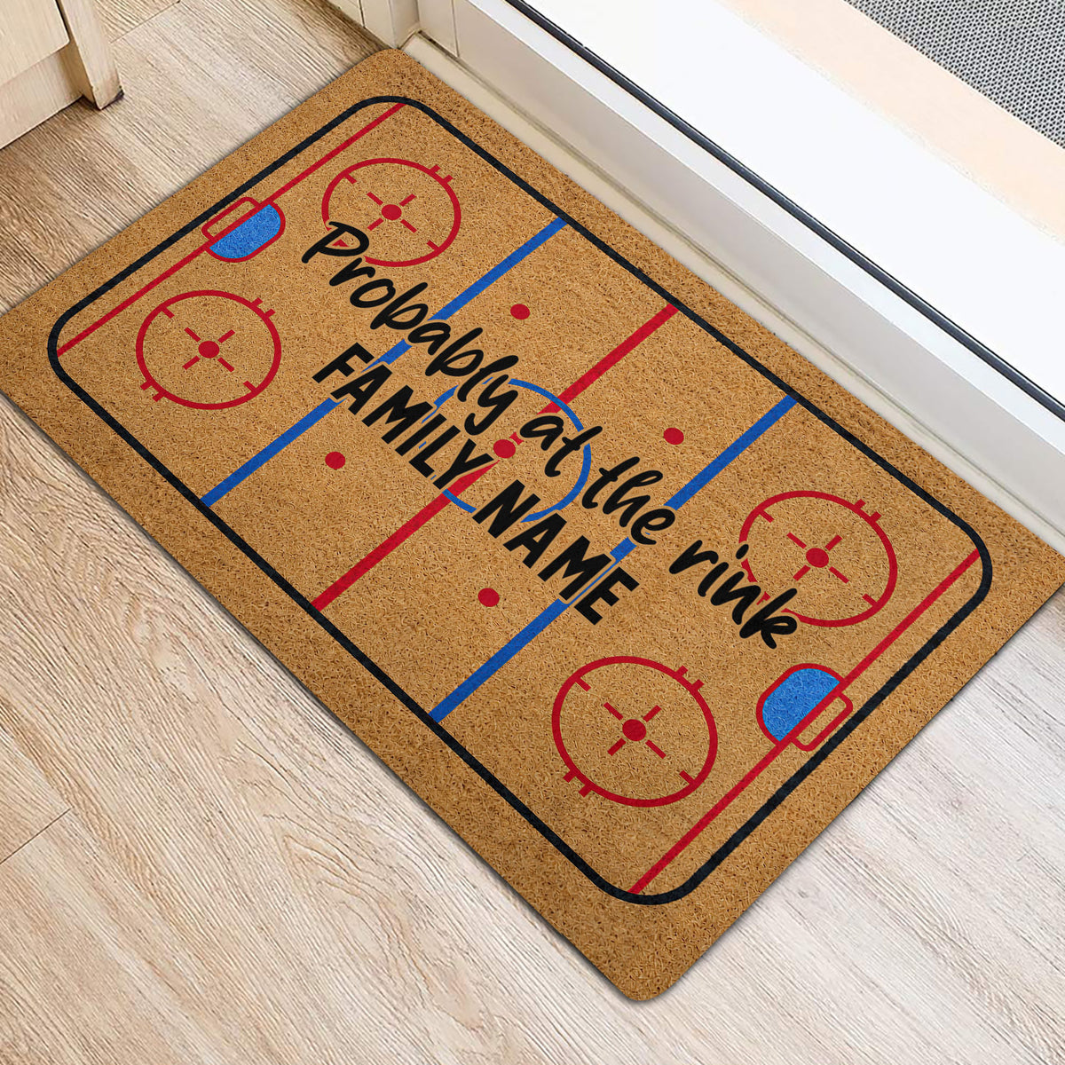 Hockey-themed door mat placed beside an entry door on light wood flooring
