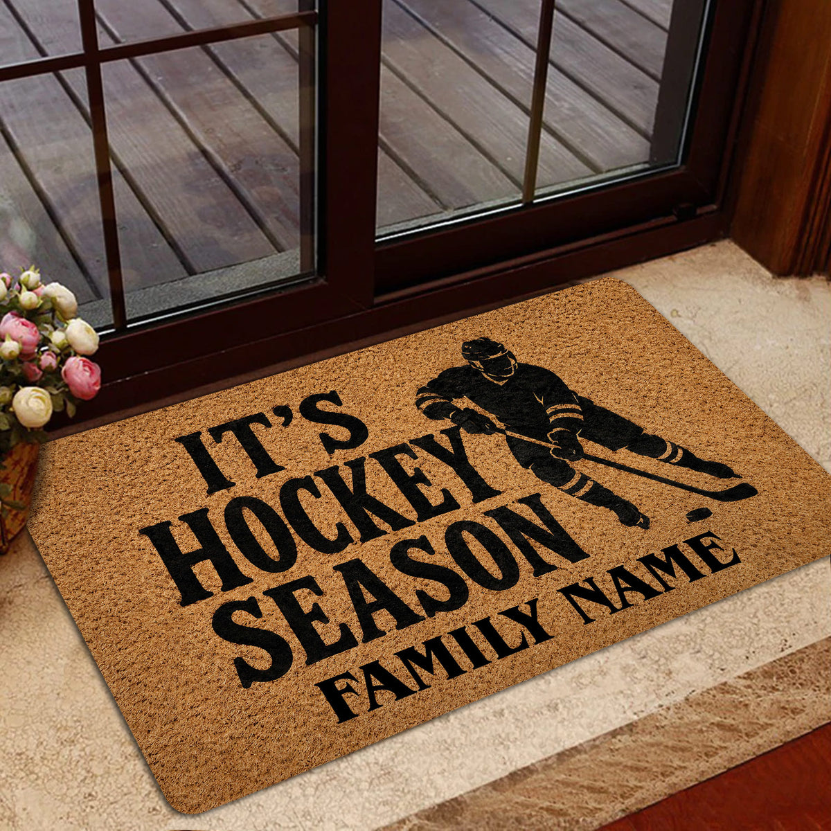 Hockey doormat presented inside a glass doorway with skater artwork and bold seasonal lettering