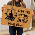 Person holding a yoga doormat displaying a meditating figure, lotus design, inspirational message, and family-focused layout