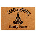 Yoga doormat with a meditating figure, lotus details, welcome lettering, and family wording on a warm brown design