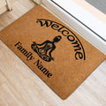 Yoga-themed welcome mat positioned beside an entrance, featuring a meditating figure and warm brown artwork
