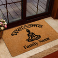Yoga doormat styled near a glass door with welcome lettering, lotus artwork, and a warm entryway presentation