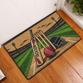 Cricket entryway rug displayed by a door with colorful pitch, bat, wickets and ball artwork