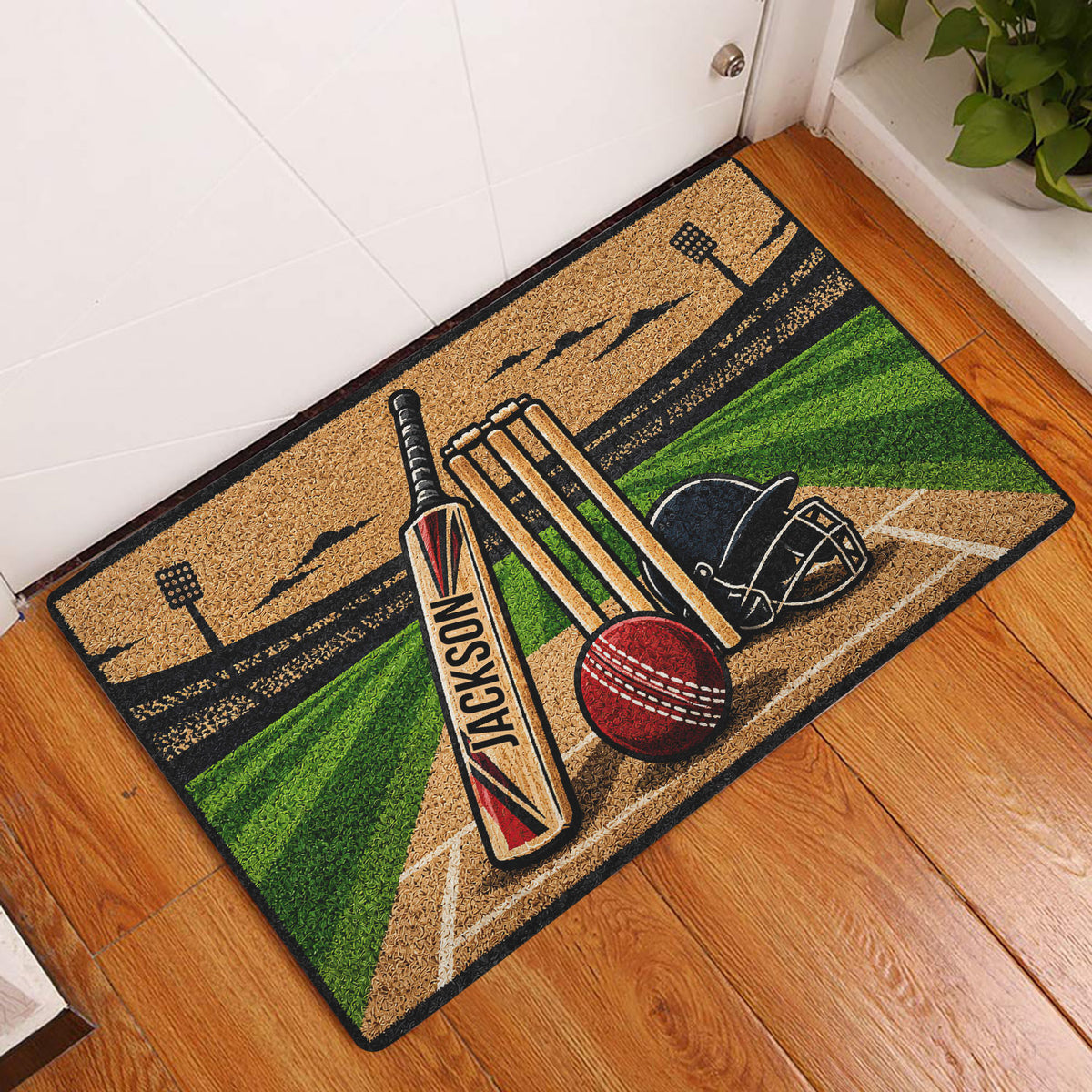 Cricket entryway rug displayed by a door with colorful pitch, bat, wickets and ball artwork