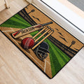 Cricket doormat positioned at an entrance, featuring a bat, wickets, helmet and pitch design