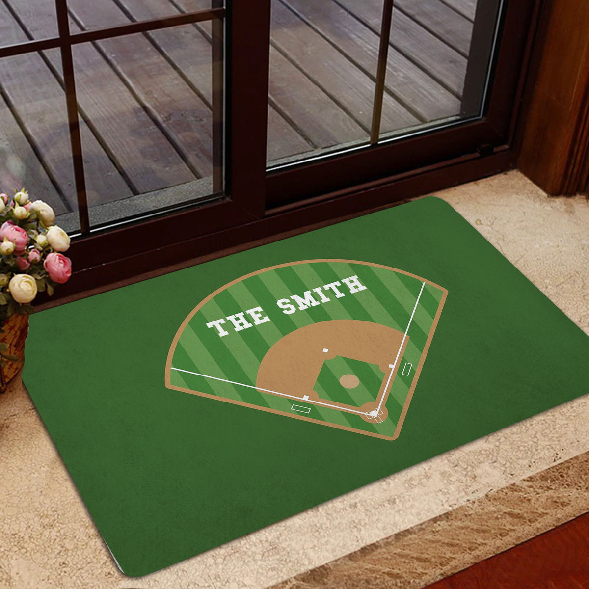 Green baseball entryway mat styled near a glass door with a ballpark diamond design