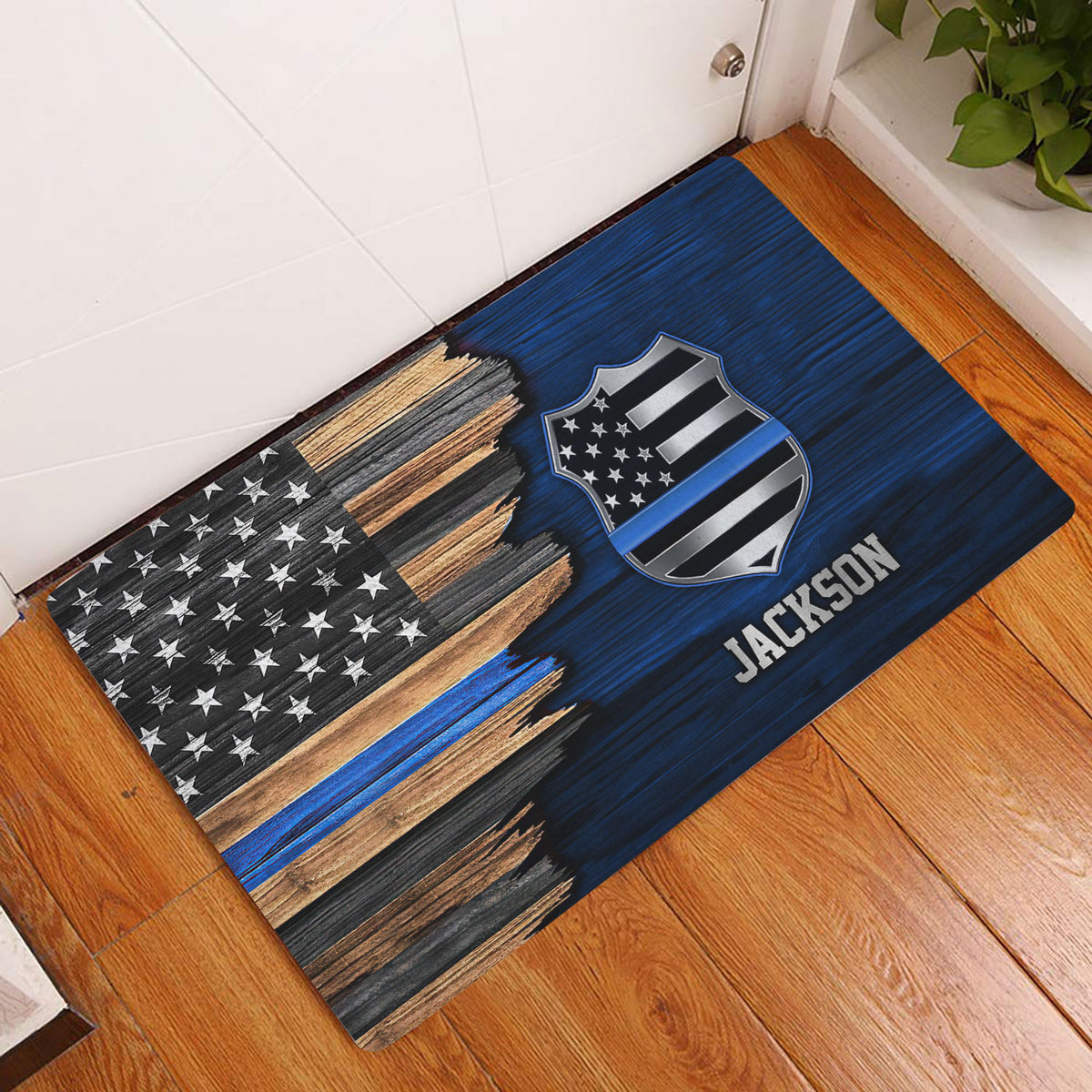Police badge and blue line American flag doormat displayed at an indoor entryway