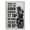 Framed motocross wall art showing a helmeted dirt bike rider with bold black motivational typography
