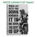 Matte canvas wall art featuring a motocross rider, dirt bike, and high-contrast motivational design