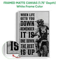 Framed matte canvas motocross wall art shown with a white frame and bold rider design