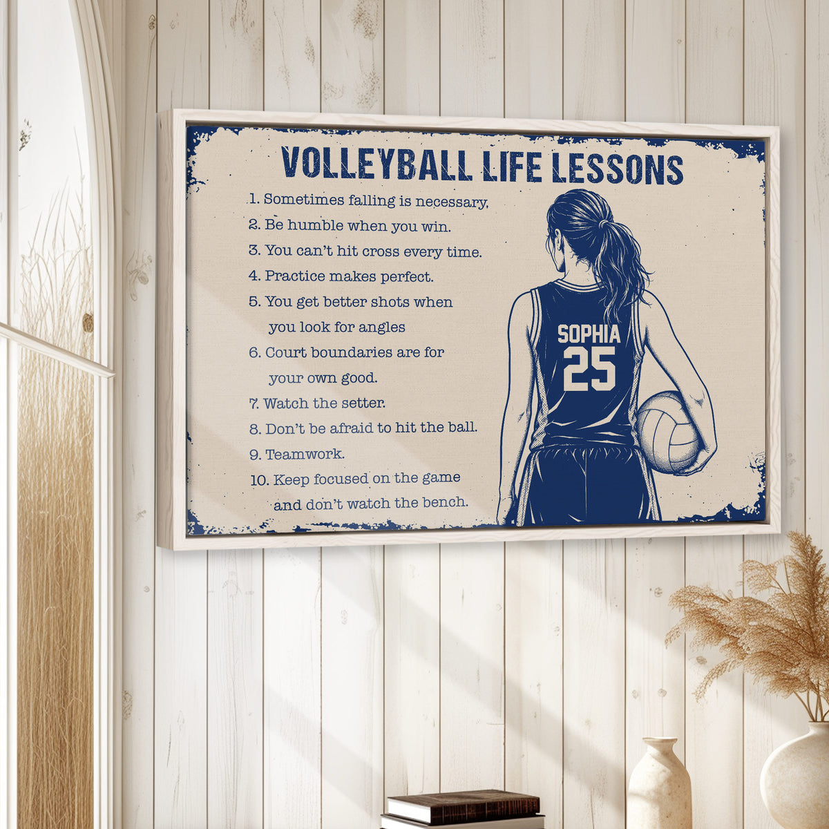 Framed volleyball wall art displayed on a light wood wall in a bright home decor setting