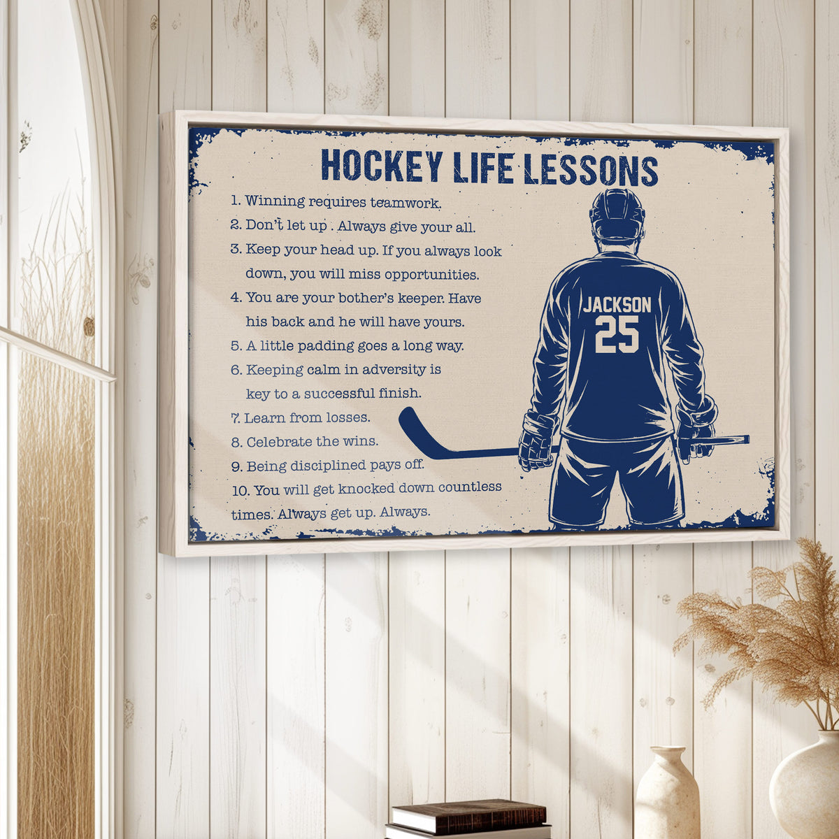 Framed hockey wall art displayed in a bright room with white wood walls and neutral decor