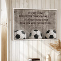 Soccer wall art displayed in a bright neutral room with wood paneling and three soccer balls