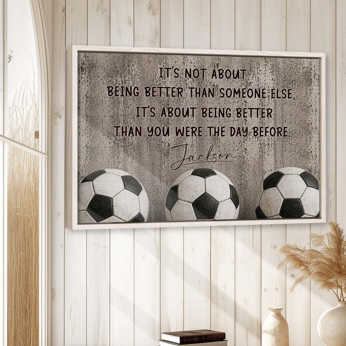 Soccer wall art displayed in a bright neutral room with wood paneling and three soccer balls