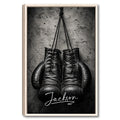 Framed boxing wall art featuring black gloves against a textured gray background