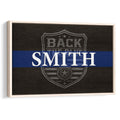 Framed police wall art with a blue stripe, badge emblem, and dark wood-style background