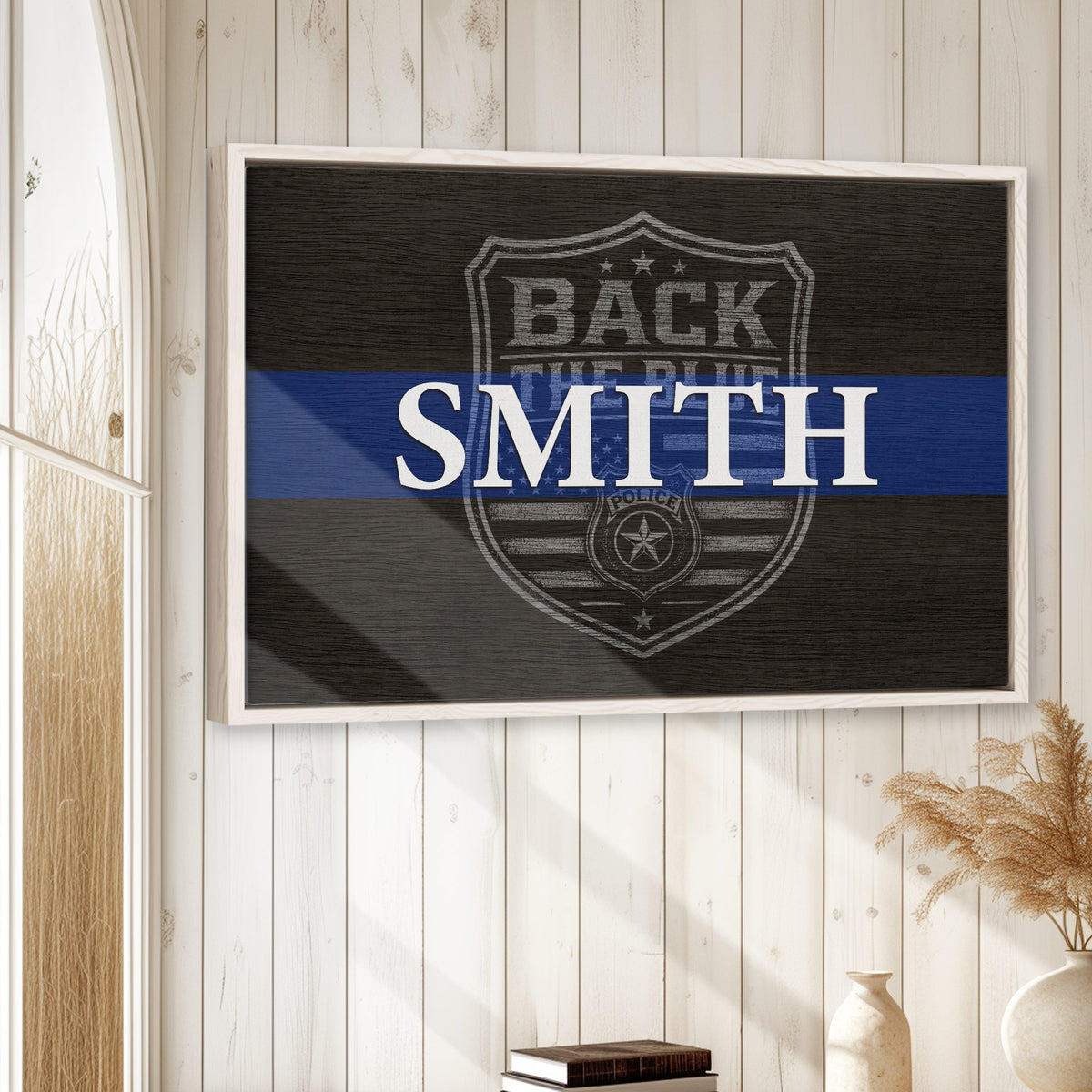Framed police wall art displayed on a light wood-paneled wall in a home setting