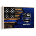 Framed police wall art with a blue-line American flag, shield emblem, and distressed wood-style background