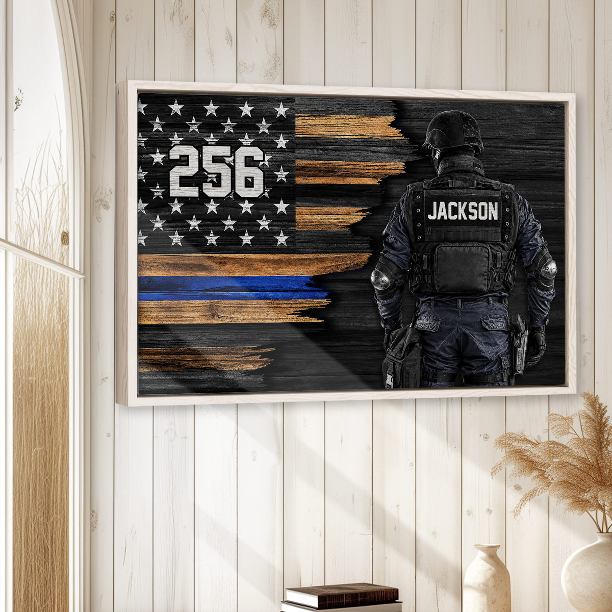 Police wall art displayed in a bright wood-paneled room, featuring a tactical officer and blue line flag