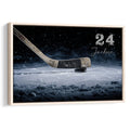 Framed hockey wall art featuring a hockey stick and puck on an icy blue rink background