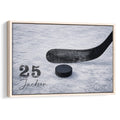 Framed hockey wall art featuring a black stick and puck on textured blue ice