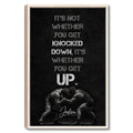 Framed wrestling wall art with two wrestlers grappling beneath a bold motivational design