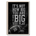 Framed football wall art with bold distressed typography, a football, and helmet on a dark background