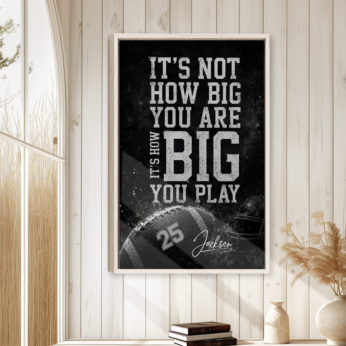 Football wall art displayed in a bright room with wood paneling, neutral decor, and a natural frame