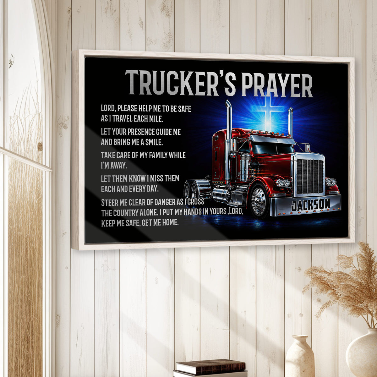 Framed trucker prayer wall art displayed on a light wood-paneled wall in a warm home setting