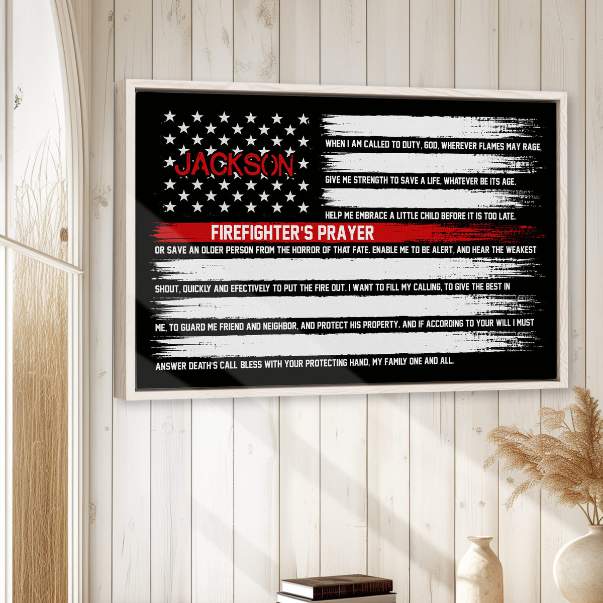Framed firefighter prayer wall art displayed on a light wood-paneled wall in a home setting