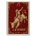 Framed cowboy bull rider wall art with a horseshoe, stars, and distressed red Western styling