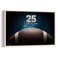 Framed football wall art featuring a close-up football against a dramatic dark blue background