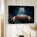Football wall art displayed in a bright room with light wood paneling and a natural wood frame