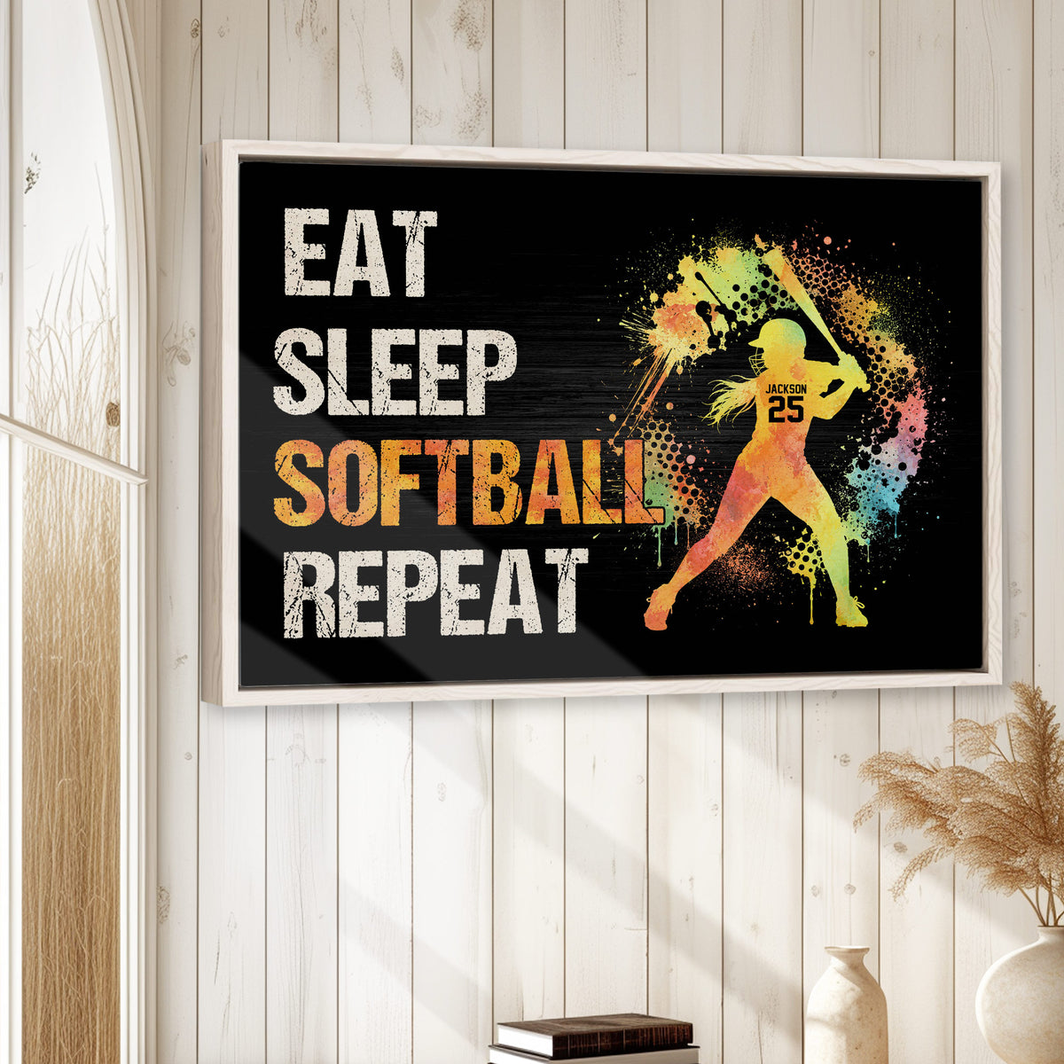 Colorful softball wall art displayed in a bright room with white wood paneling