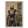 Framed football wall art showing a helmeted player in a stadium with sepia motivational typography