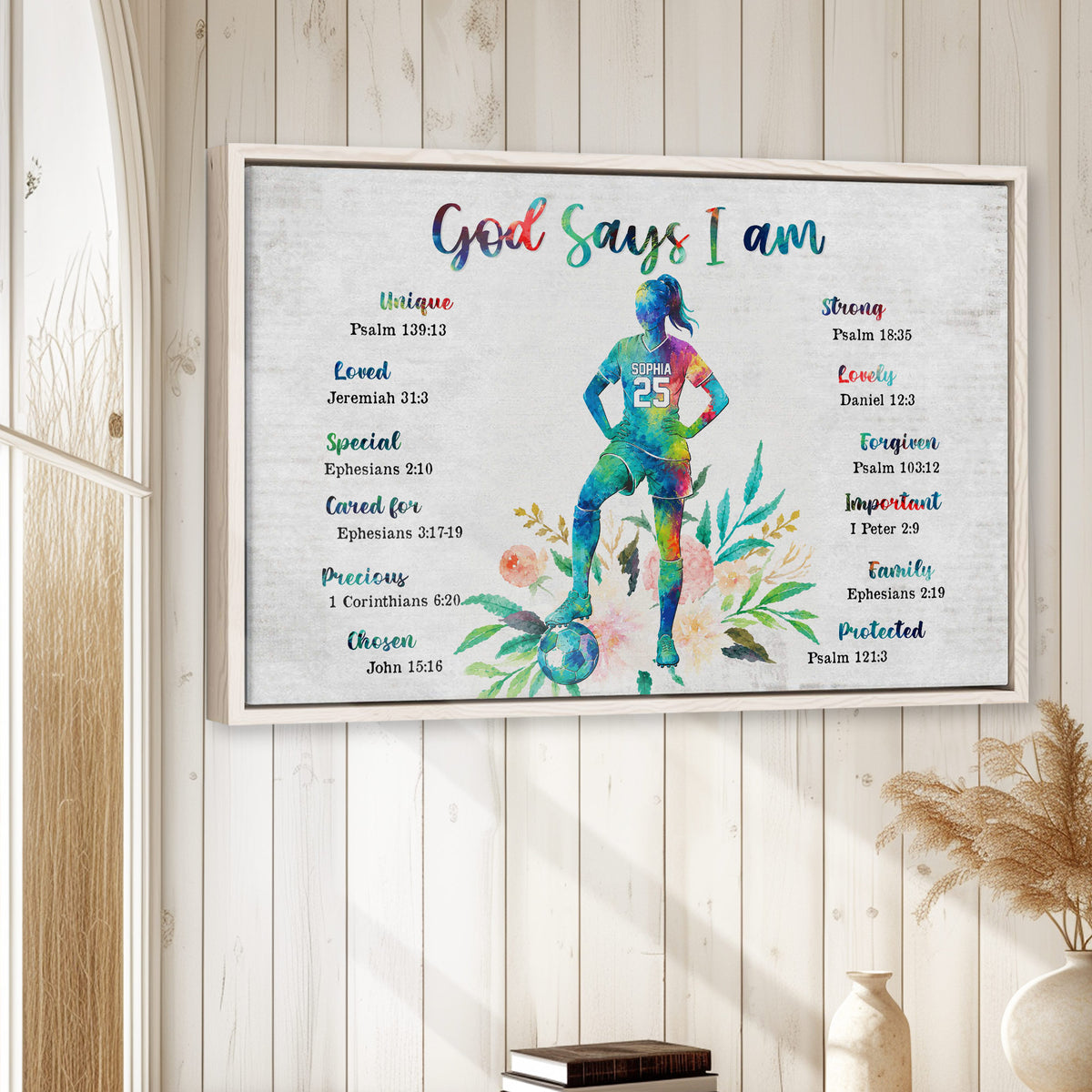 Framed soccer wall art displayed in a bright neutral room with a colorful player and floral faith-inspired design