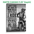 Matte canvas motocross wall art featuring a helmeted rider on a dirt bike in a grayscale design