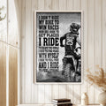 Framed motocross wall art displayed on a light wood-paneled wall in a bright home decor setting