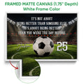 White framed soccer canvas wall art featuring a stadium, soccer ball, green field, and bold typography